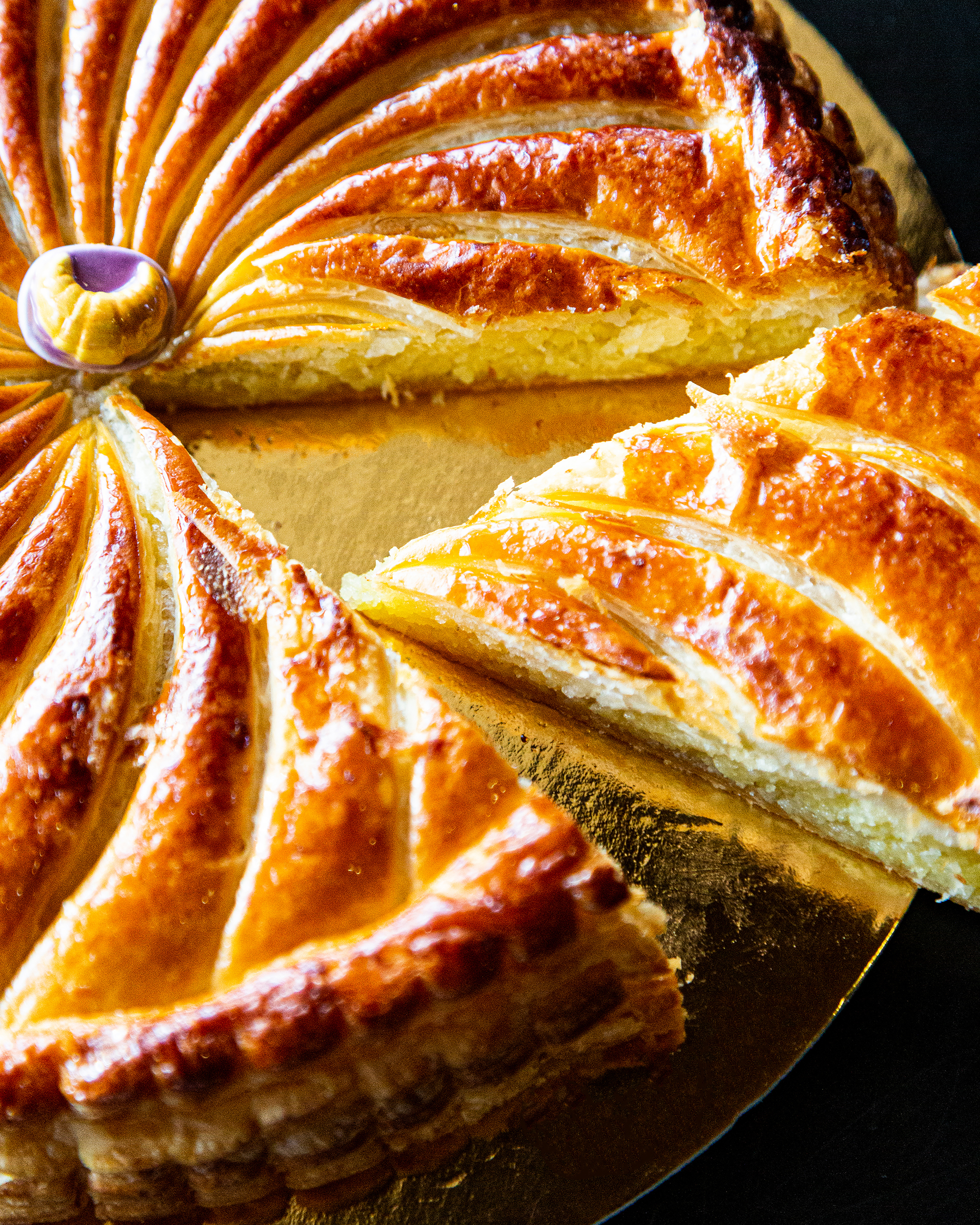 kings cake with a slice being pulled out.